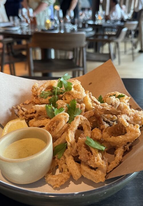 Lightly fried calamari, crisp on the outside and tender within, brightened with a squeeze of fresh lemon.